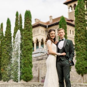 Bride and groom at their Tuscany wedding in front of a historic castle