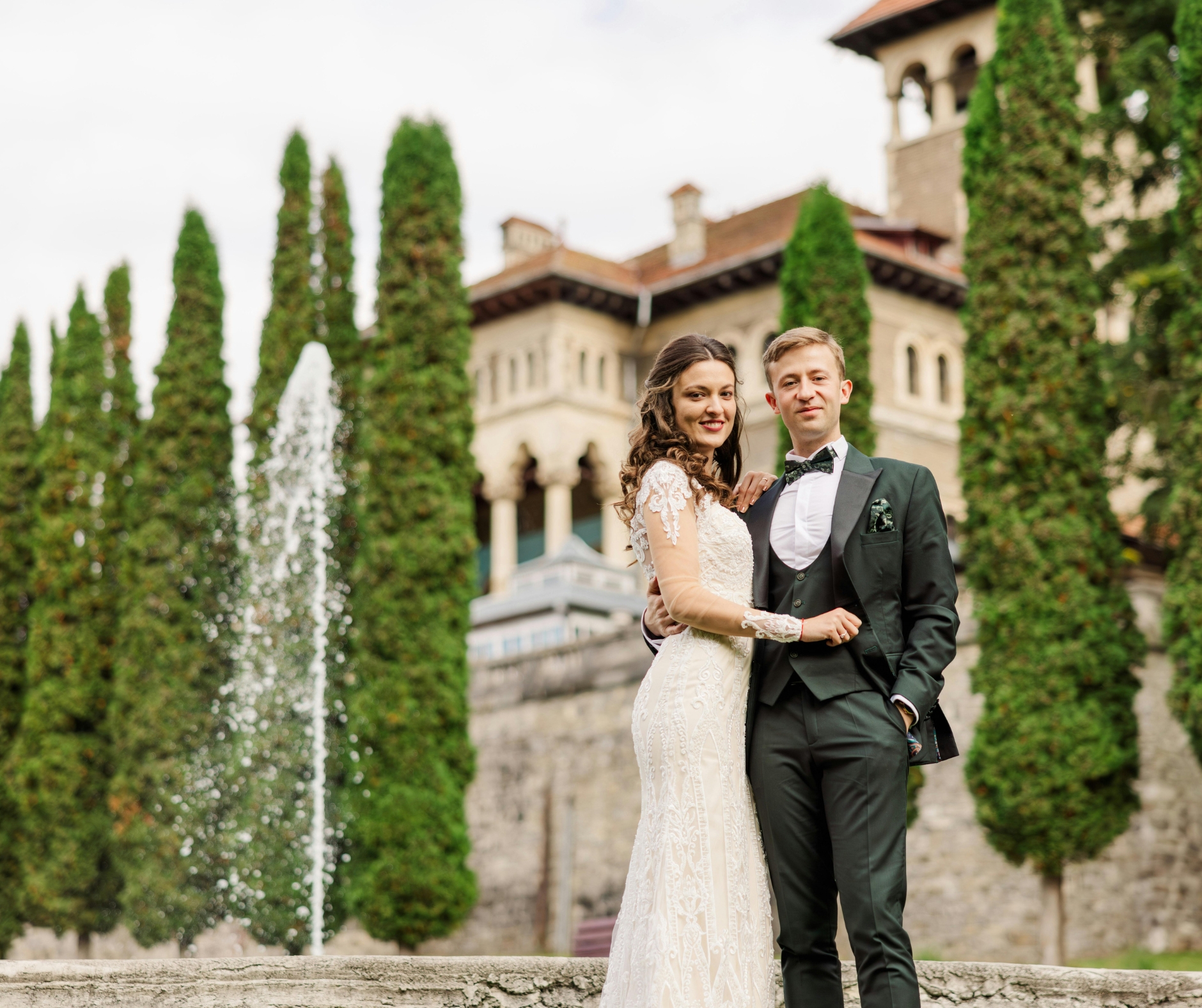 Bride and groom at their Tuscany wedding in front of a historic castle